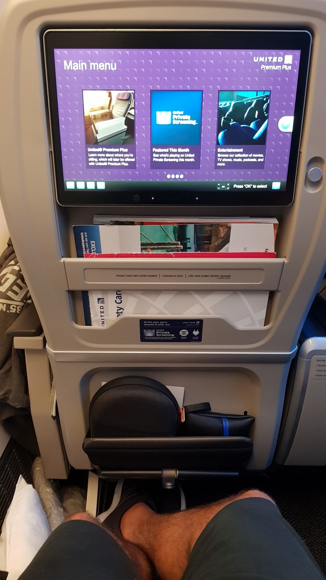 United Airlines Premium Plus seat showing generous pitch and width